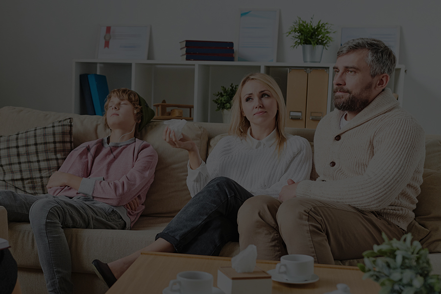 Parent and teenager talking with a counselor