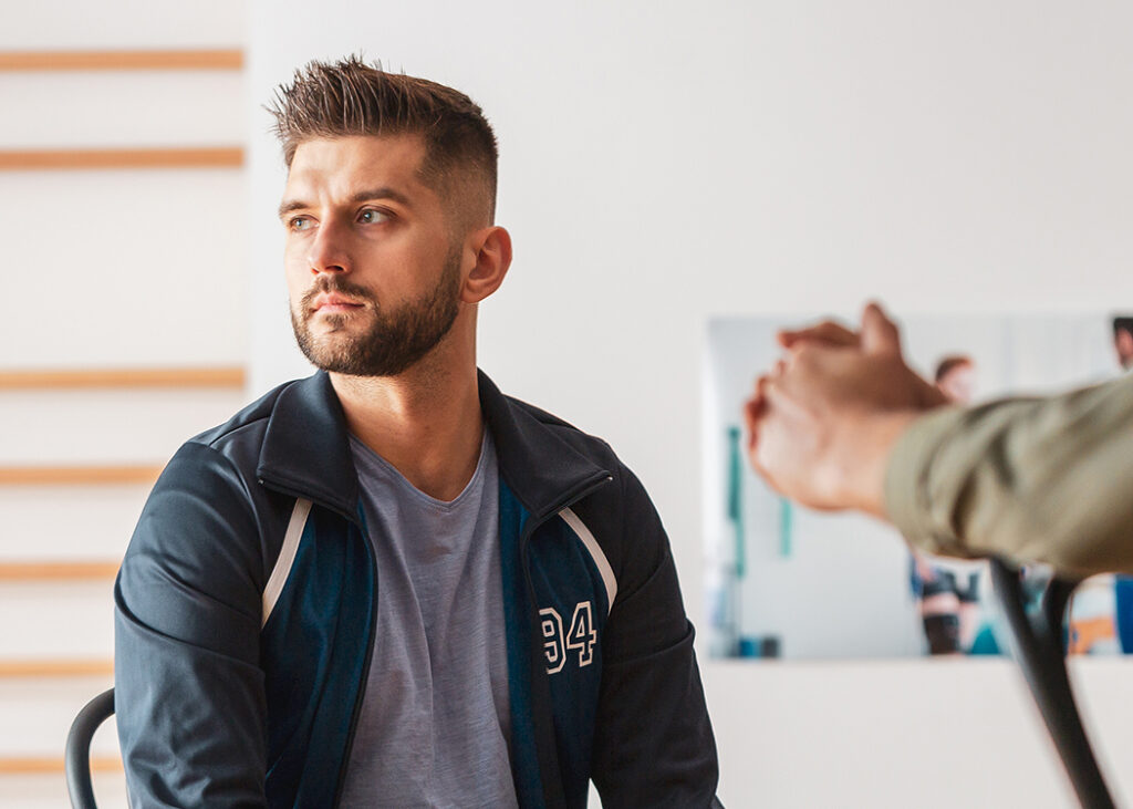 Man seated in a counseling session looking away